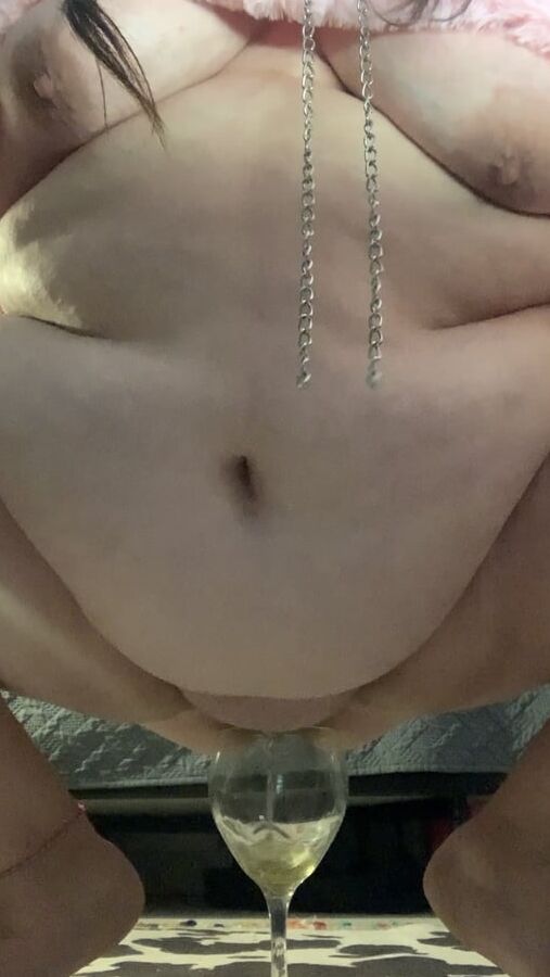 Fat piggy squats over wine glass