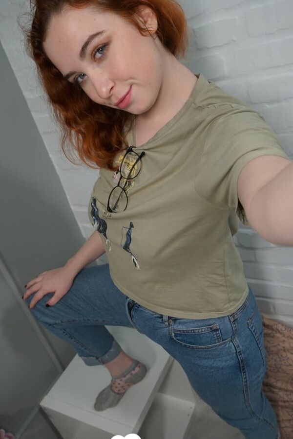Stunning redhead in stockings shows off her ass
