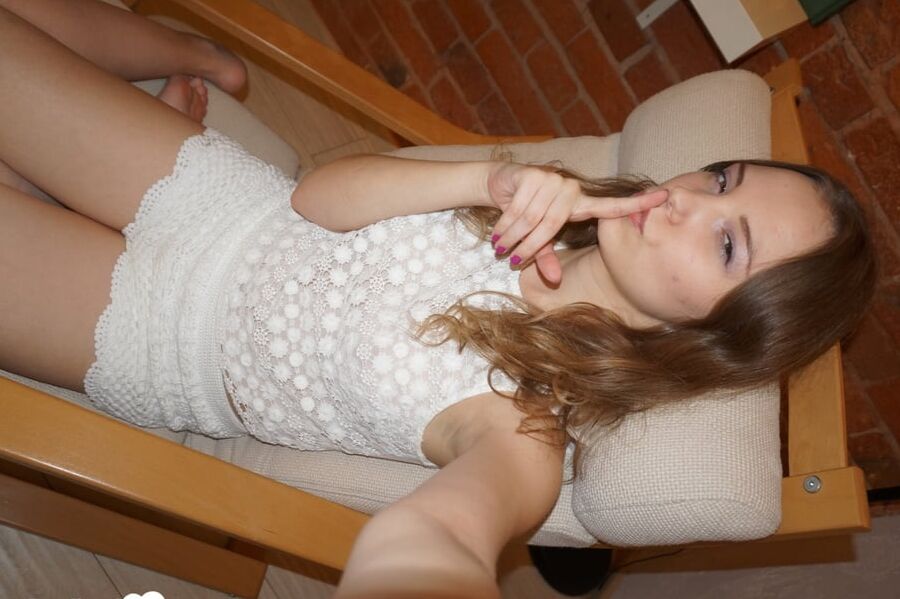 Smoking teen posing in a sexy schoolgirl outfit