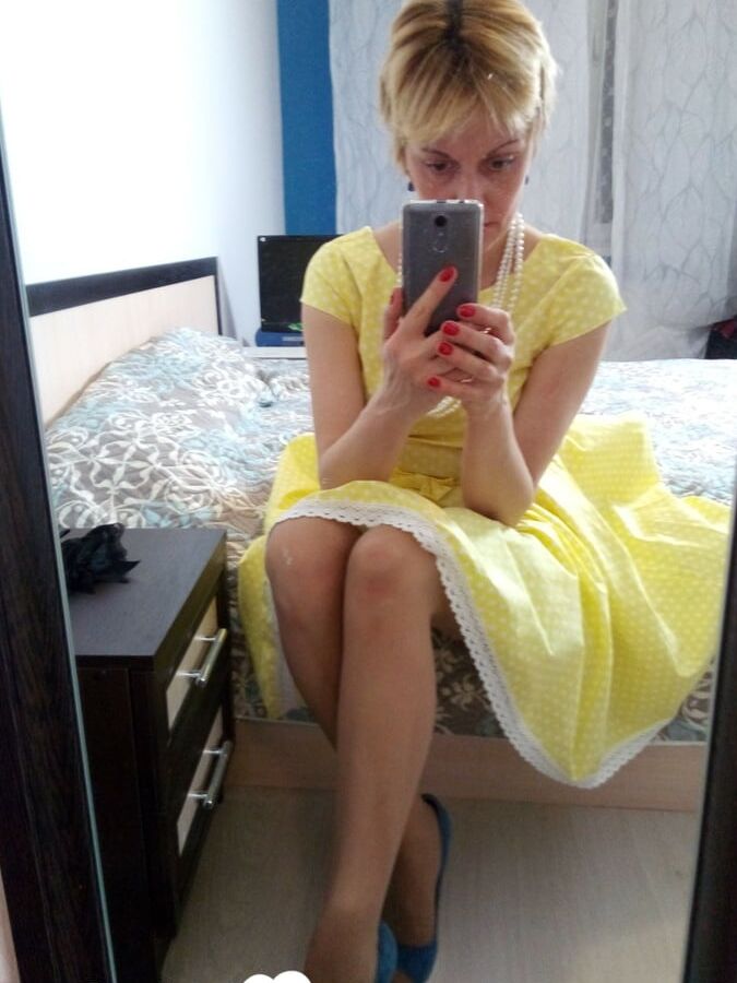 Stunning MILF puts on a yellow dress