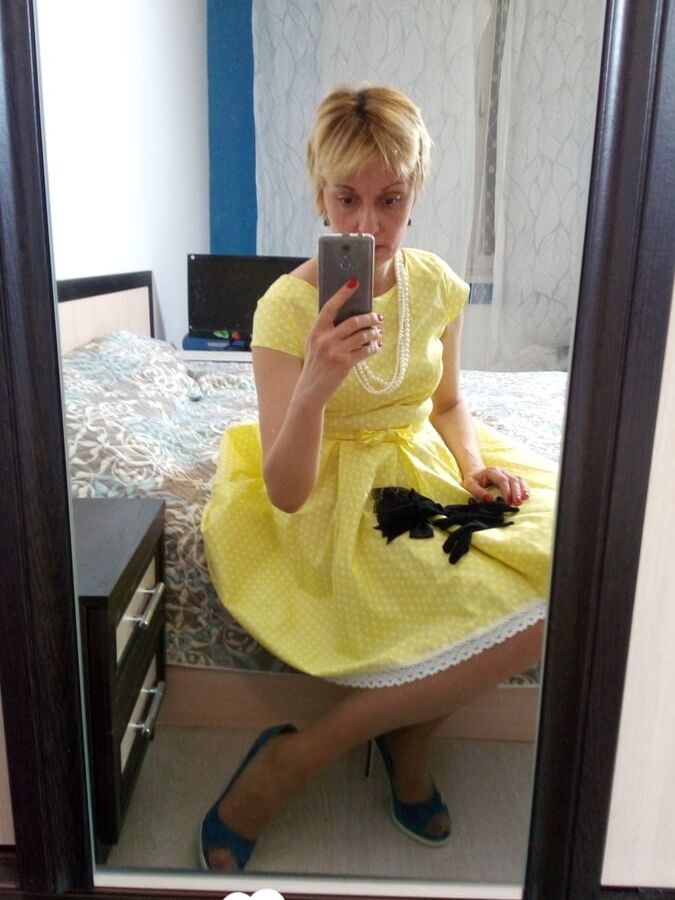 Stunning MILF puts on a yellow dress