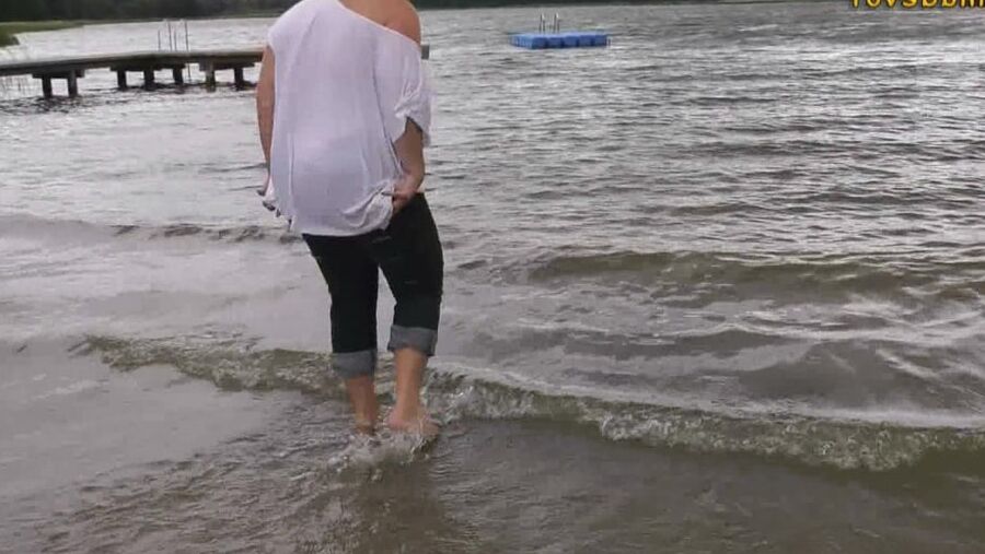 With RIPPED JEANS into the lake