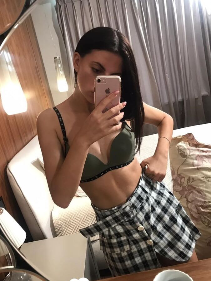 Hot schoolgirl reveals her tits in the mirror
