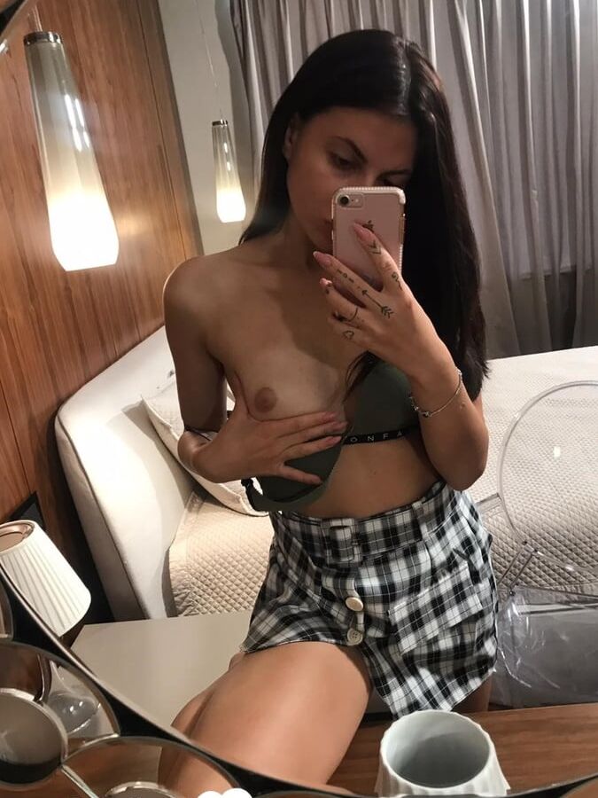 Hot schoolgirl reveals her tits in the mirror