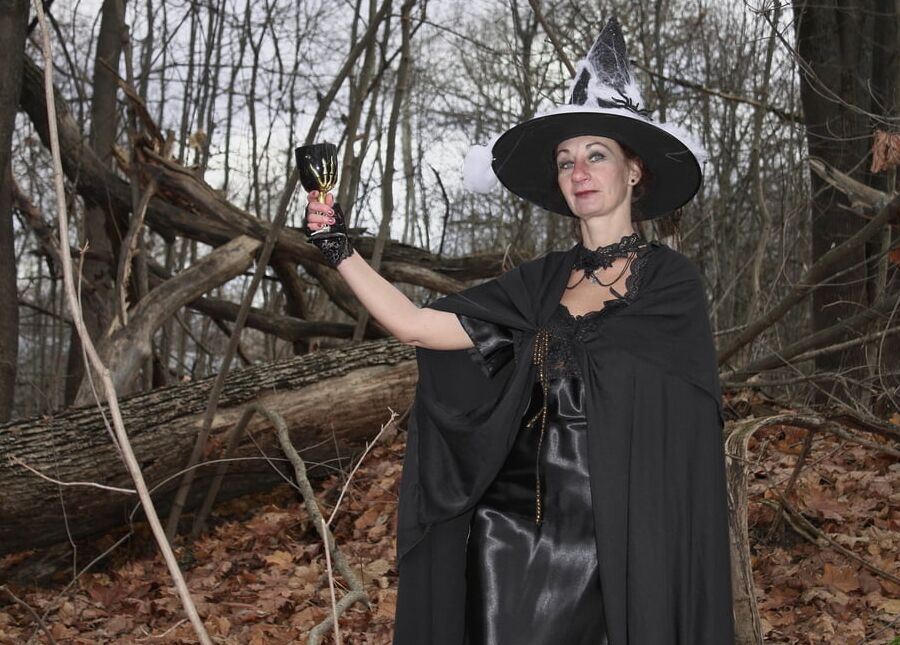 Witch with broom in forest