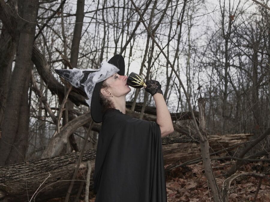 Witch with broom in forest