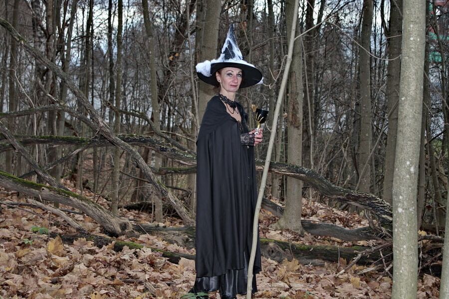 Witch with broom in forest