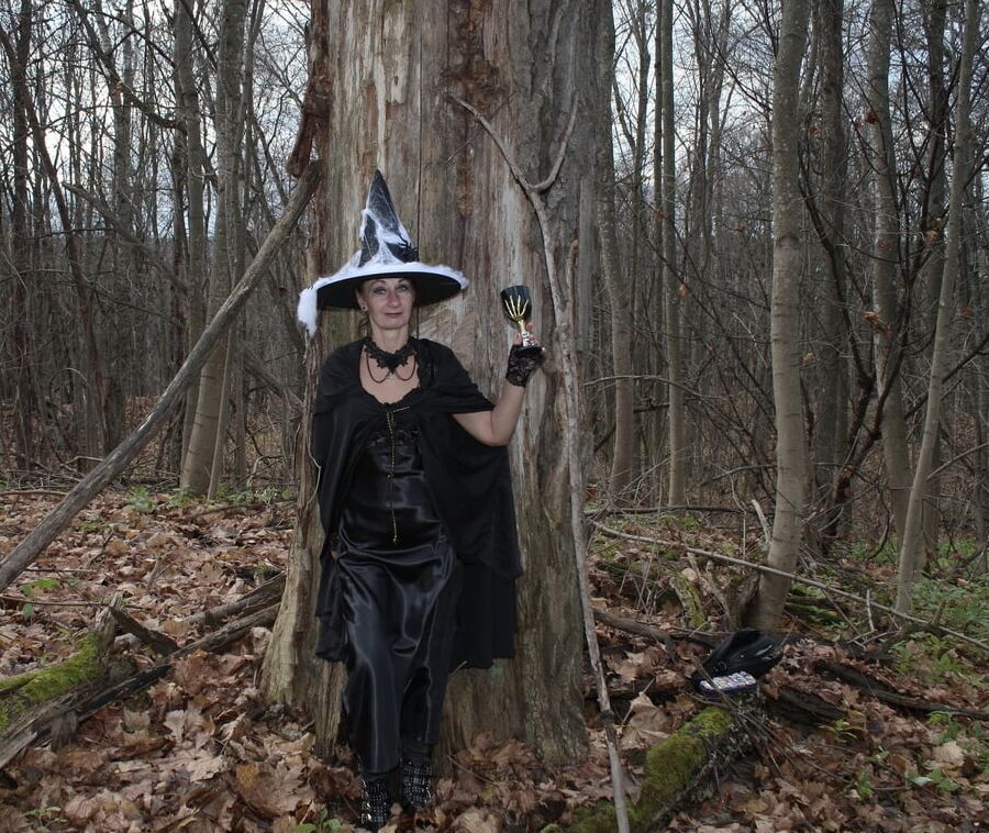 Witch with broom in forest