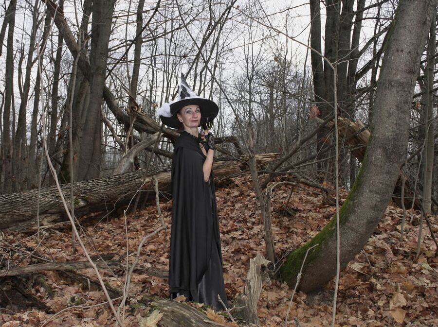 Witch with broom in forest