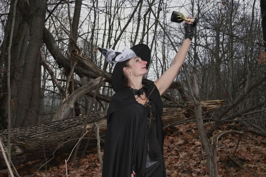 Witch with broom in forest