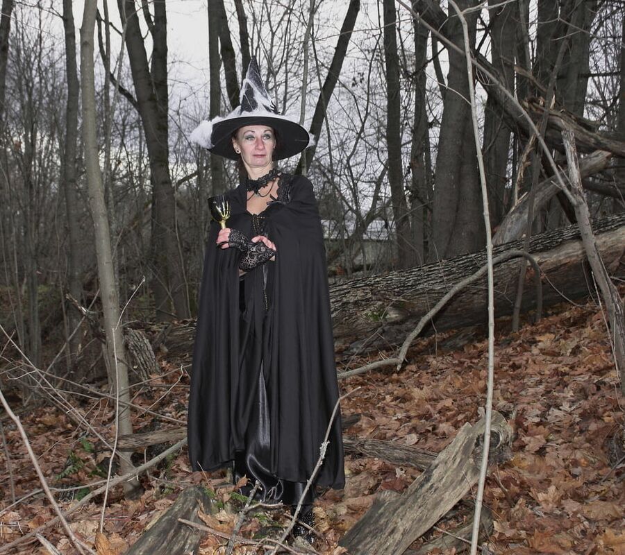 Witch with broom in forest