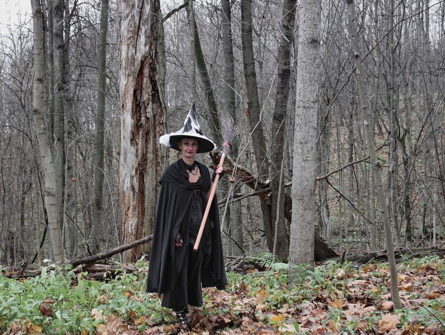 Witch with broom in forest
