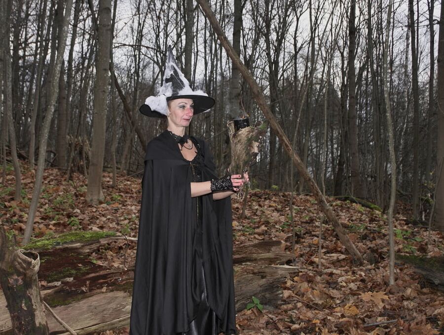 Witch with broom in forest