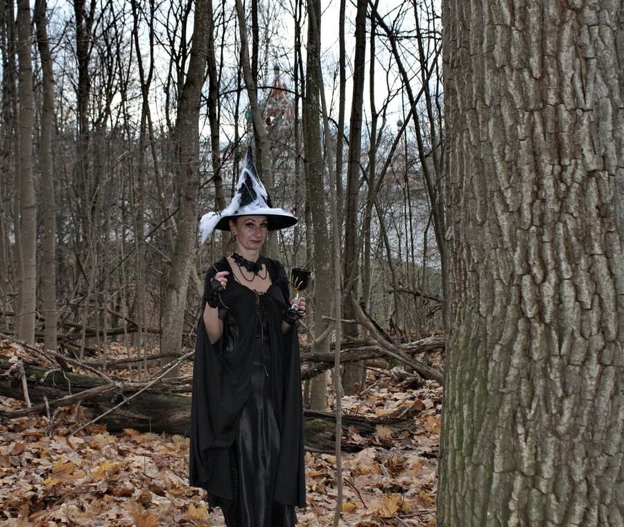 Witch with broom in forest