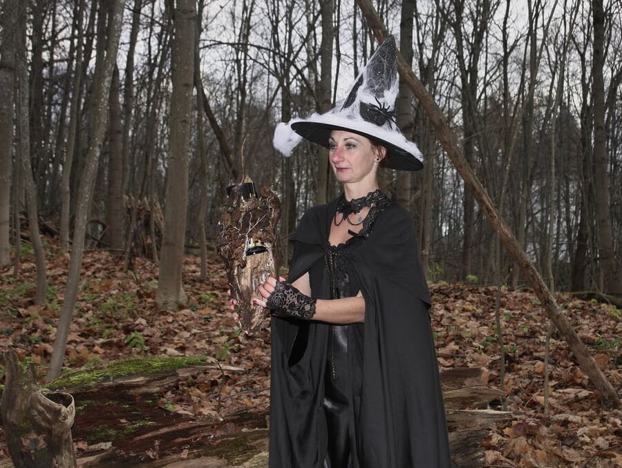 Witch with broom in forest