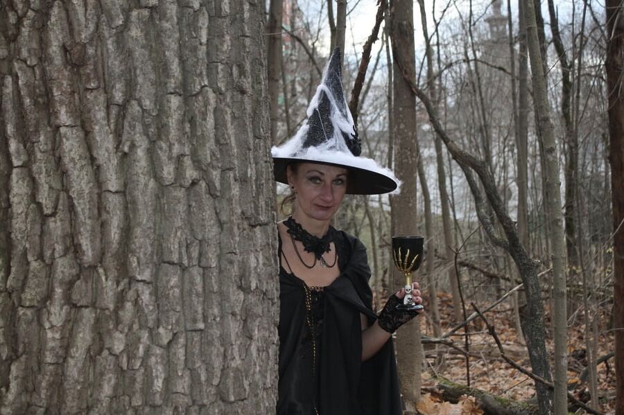 Witch with broom in forest