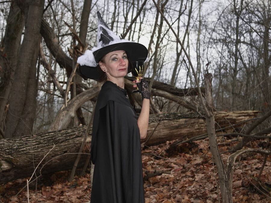 Witch with broom in forest
