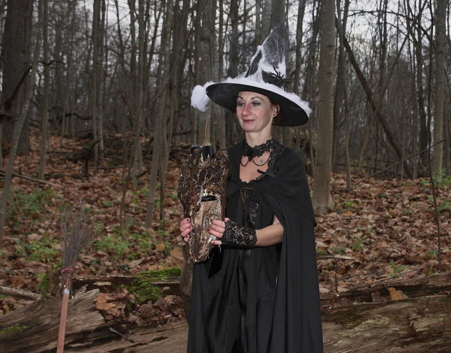 Witch with broom in forest