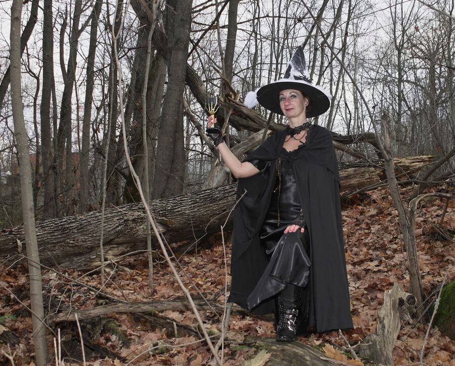 Witch with broom in forest