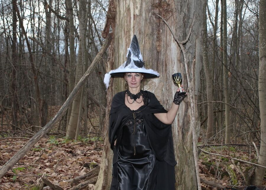 Witch with broom in forest
