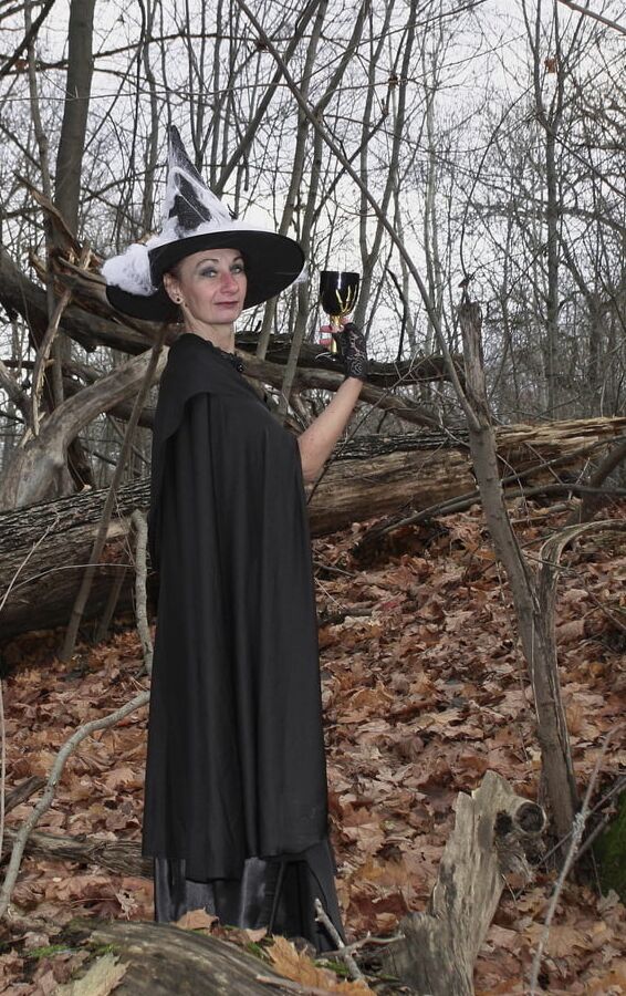 Witch with broom in forest