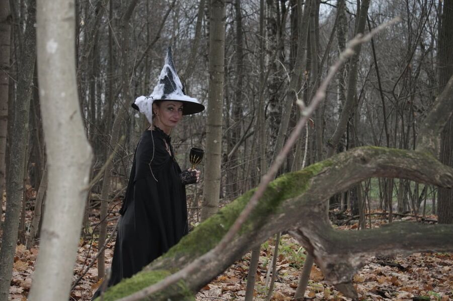 Witch with broom in forest