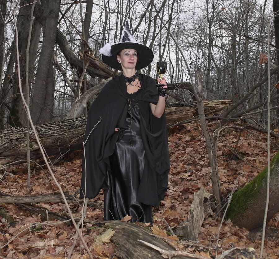 Witch with broom in forest
