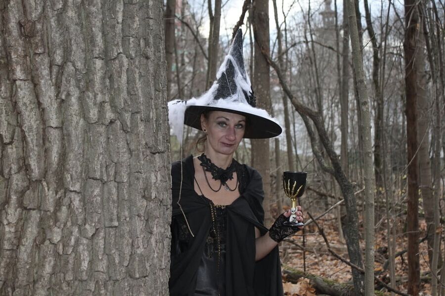 Witch with broom in forest