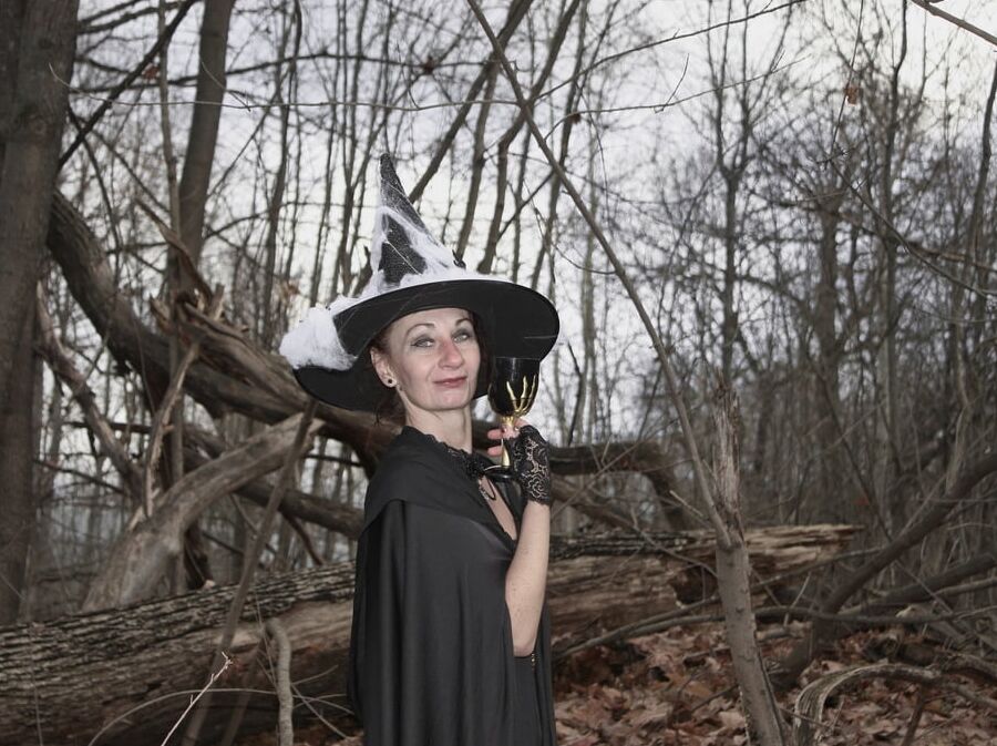 Witch with broom in forest