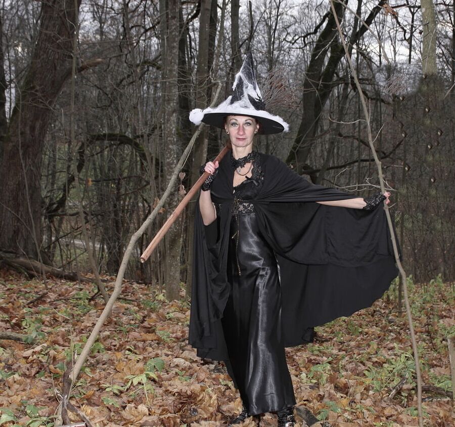 Witch with broom in forest