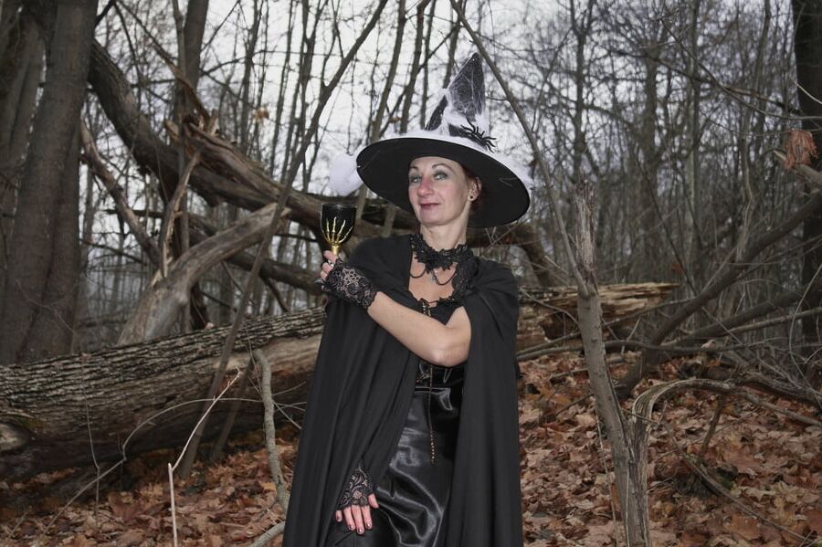 Witch with broom in forest