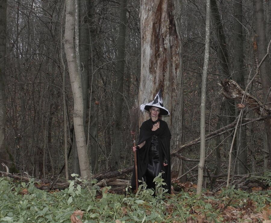 Witch with broom in forest