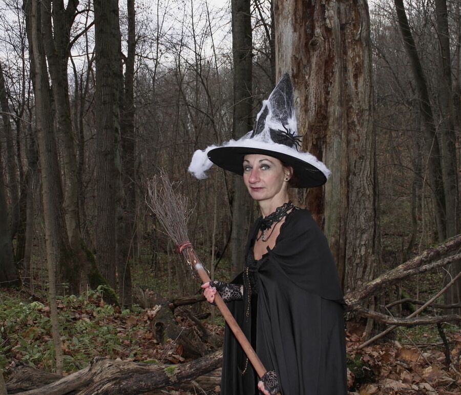 Witch with broom in forest