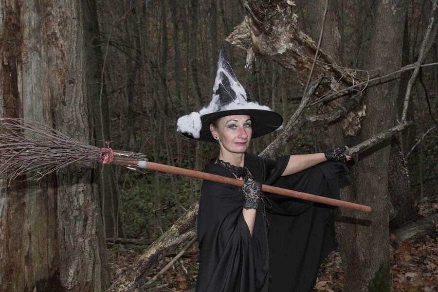 Witch with broom in forest