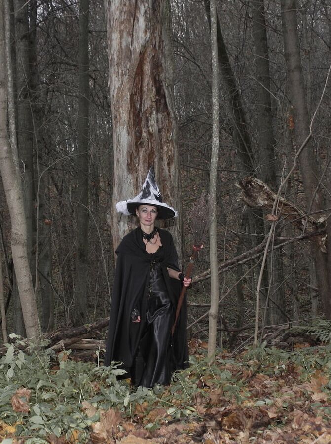 Witch with broom in forest