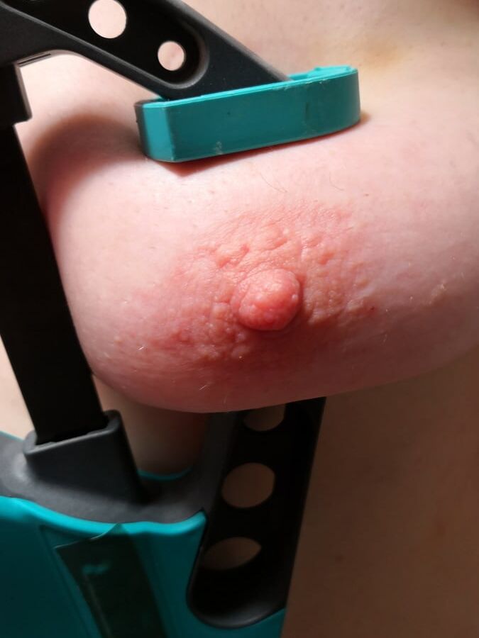 Tits squeezed with clamps