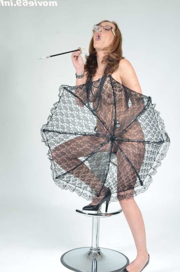 MILF Lea Blow smoking nude with a see-through umbrella