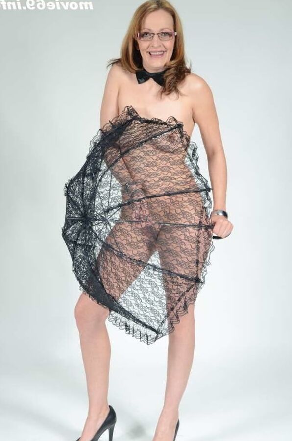 MILF Lea Blow smoking nude with a see-through umbrella