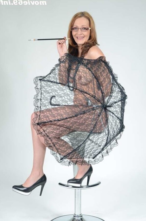 MILF Lea Blow smoking nude with a see-through umbrella