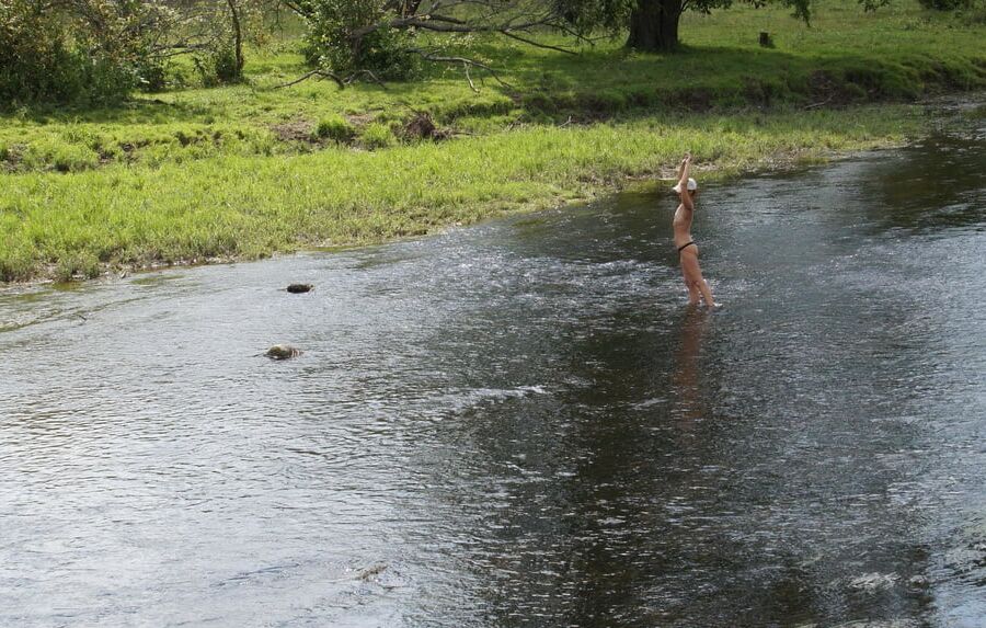 Nude in river's water