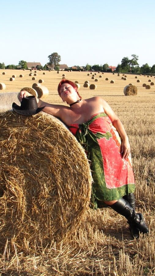 Anna naked on straw bales ...