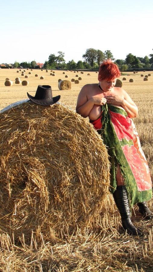 Anna naked on straw bales ...
