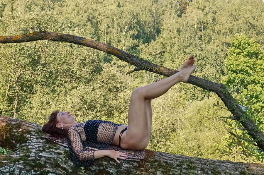 Nude on the tree trunk