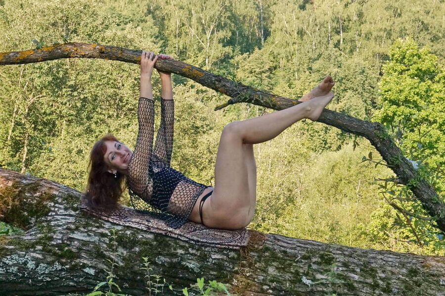 Nude on the tree trunk