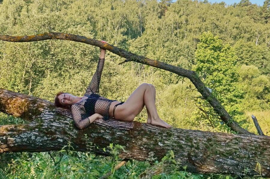 Nude on the tree trunk