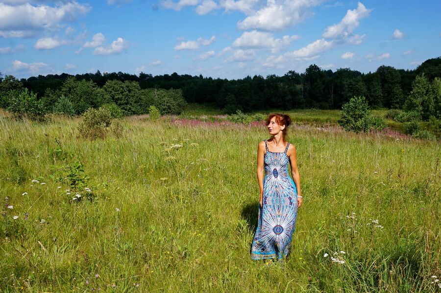 In blue dress in field