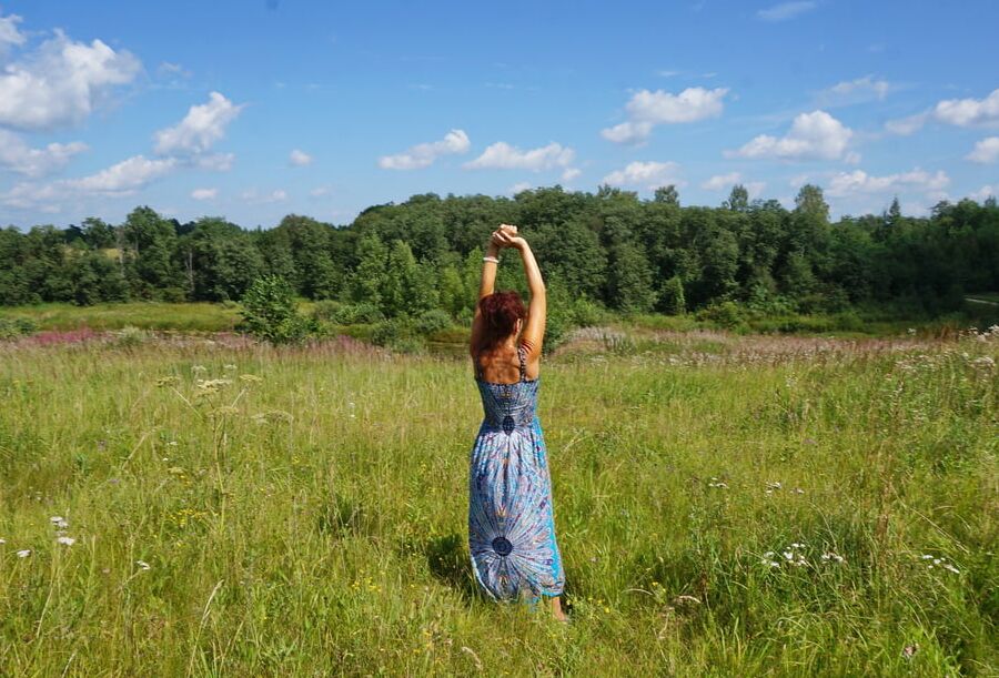 In blue dress in field