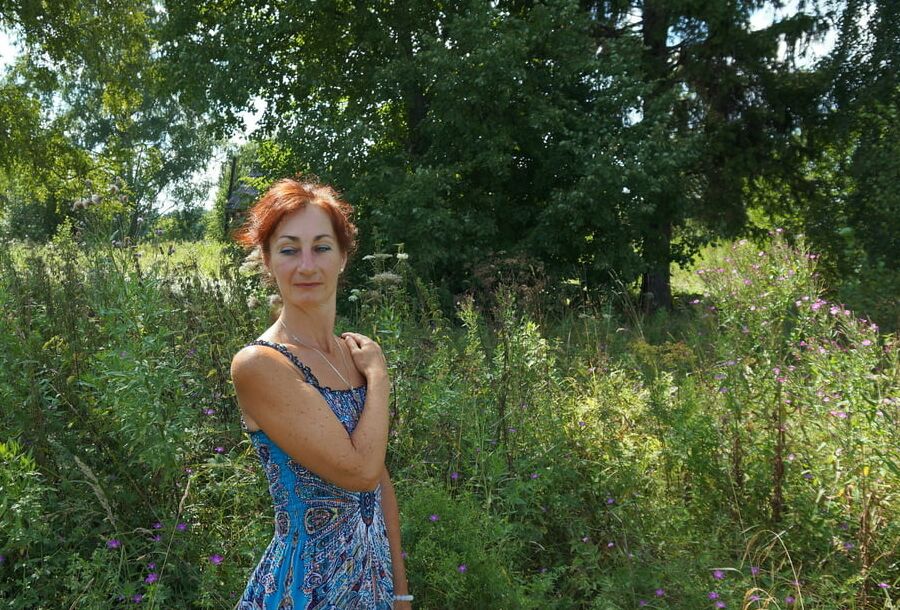 In blue dress in field
