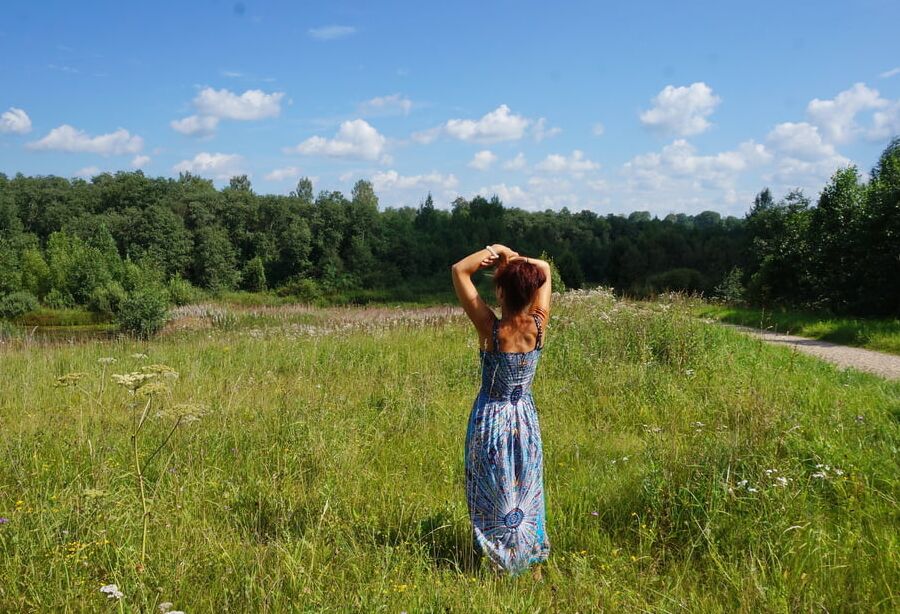 In blue dress in field