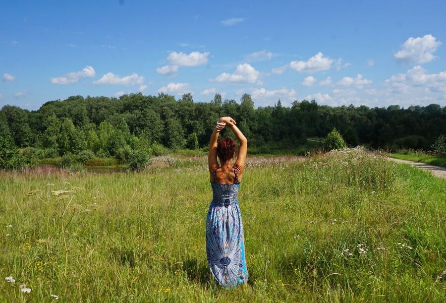 In blue dress in field